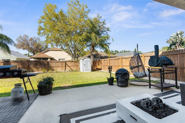 view of patio / terrace with a storage shed, a fenced backyard, an outdoor structure, and a fire pit