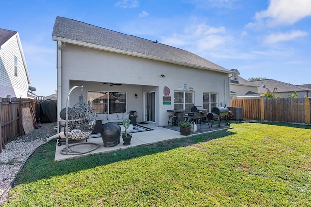 back of house featuring stucco siding, a patio, a yard, and a fenced backyard