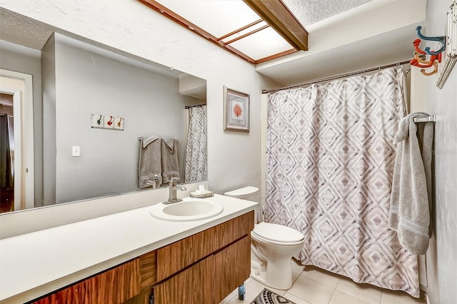 full bathroom featuring toilet, a textured ceiling, tile patterned flooring, and vanity