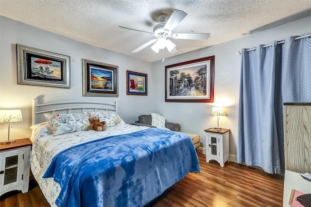 bedroom featuring a textured ceiling, a ceiling fan, and wood finished floors