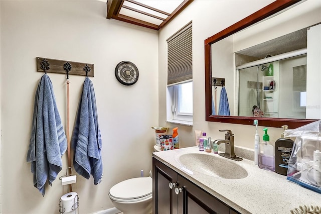 full bathroom featuring toilet, a shower stall, and vanity