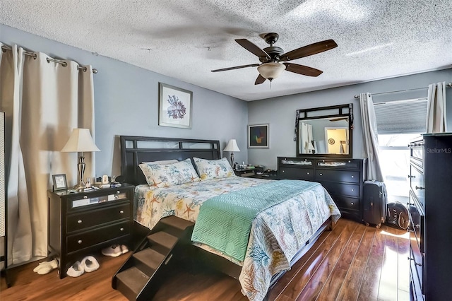 bedroom featuring a textured ceiling, ceiling fan, and wood finished floors