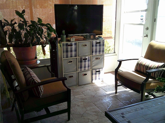 living area with stone tile floors