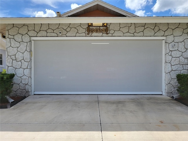 garage featuring concrete driveway