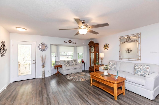 living room featuring ceiling fan, a textured ceiling, wood finished floors, and baseboards