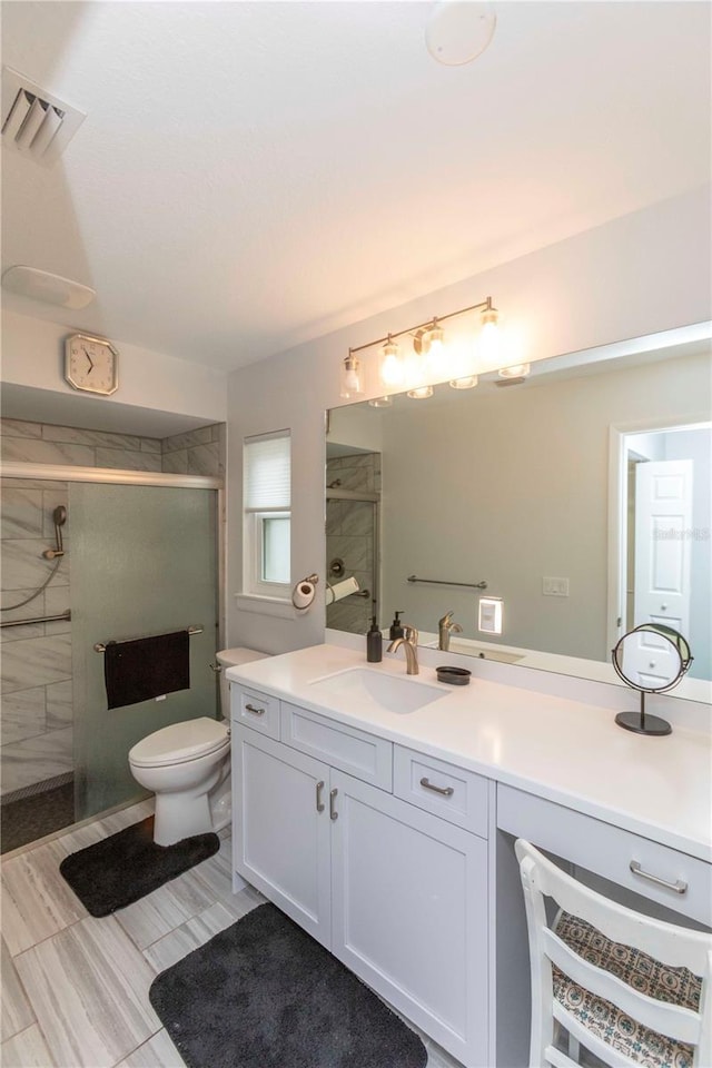 full bathroom featuring visible vents, toilet, a shower stall, and vanity