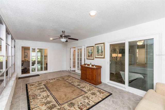 interior space with ceiling fan and french doors