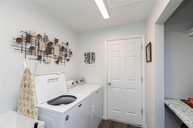 clothes washing area featuring a sink, laundry area, washing machine and clothes dryer, and dark wood-style floors