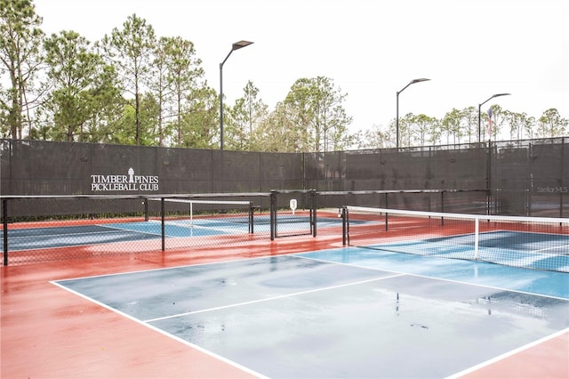 view of sport court featuring fence