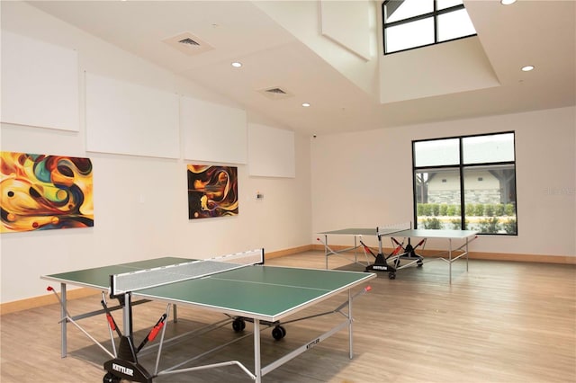 game room with light wood-type flooring, visible vents, and baseboards