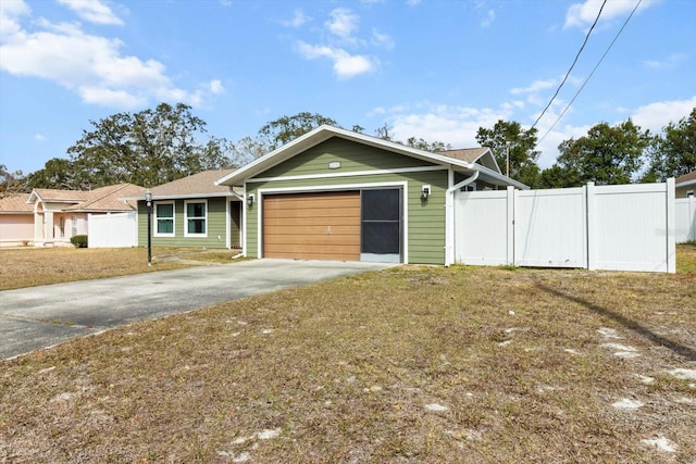 5441 Alderwood St, Spring Hill, FL 34606 - view of front of property featuring an attached garage, fence, a front lawn, and concrete driveway