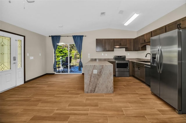 kitchen featuring a sink, under cabinet range hood, dark brown cabinetry, appliances with stainless steel finishes, and light countertops