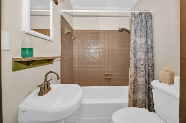 full bathroom with a sink, toilet, and shower / bath combination with curtain