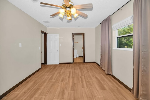 unfurnished bedroom with ceiling fan, baseboards, and wood finish floors