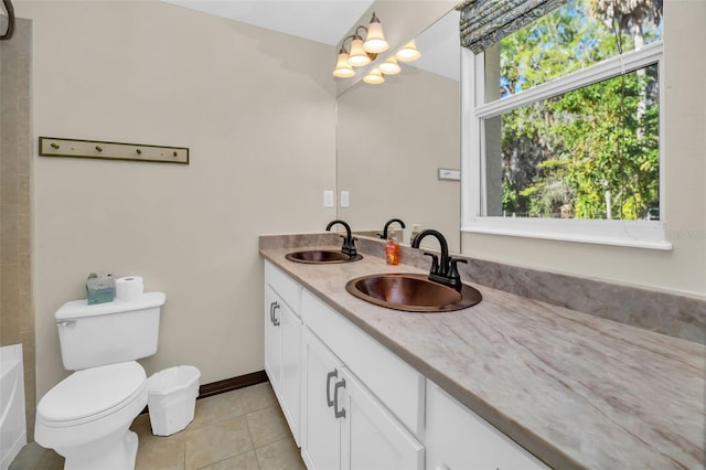 full bath with a sink, toilet, a tub to relax in, and double vanity