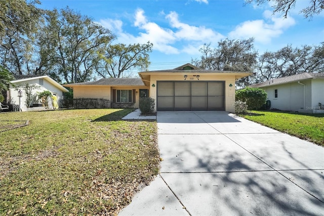 single story home featuring a garage, concrete driveway, and a front yard