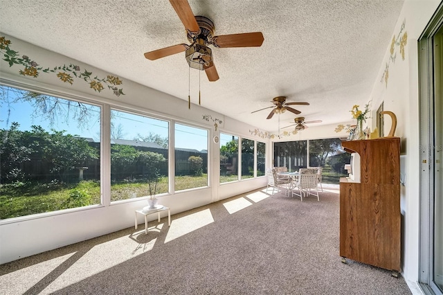 unfurnished sunroom with ceiling fan