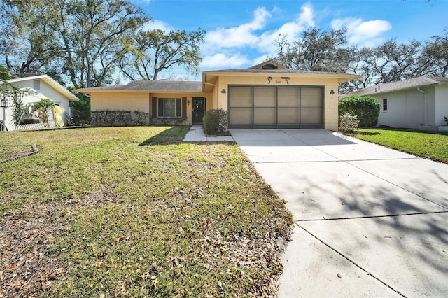 8420 Winding Wood Dr, Port Richey, FL 34668 - view of front of home with an attached garage, stucco siding, concrete driveway, and a front yard