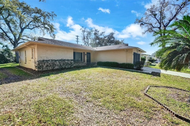8420 Winding Wood Dr, Port Richey, FL 34668 - view of front of property with a front yard and stucco siding