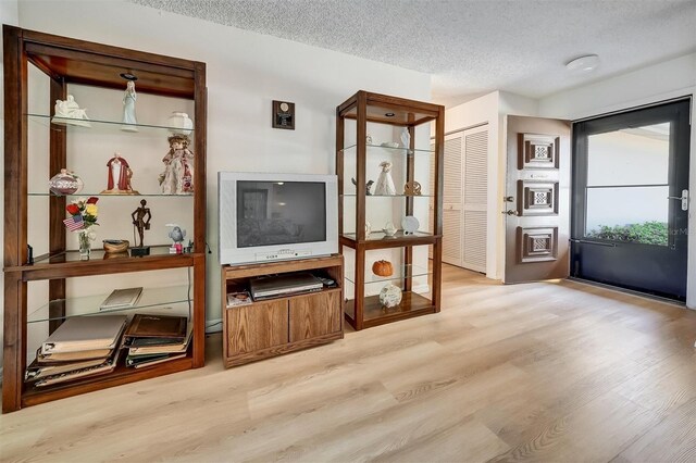 8420 Winding Wood Dr, Port Richey, FL 34668 - living area featuring a textured ceiling and wood finished floors
