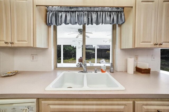 8420 Winding Wood Dr, Port Richey, FL 34668 - kitchen with washer / dryer, a sink, light countertops, light brown cabinets, and backsplash