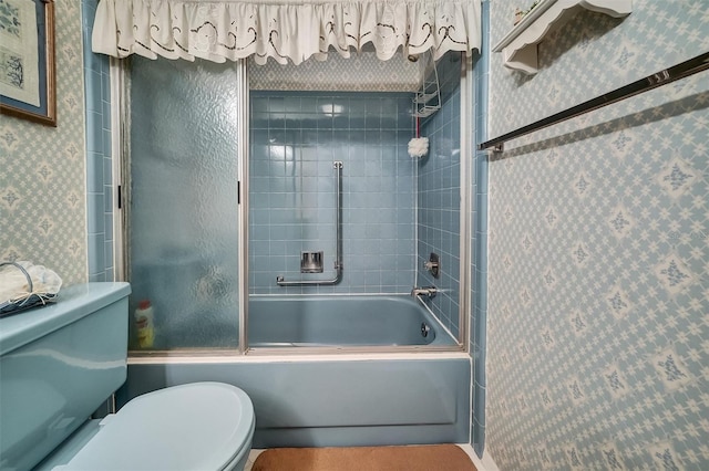 8420 Winding Wood Dr, Port Richey, FL 34668 - full bath with toilet, wallpapered walls, and shower / bath combination with glass door