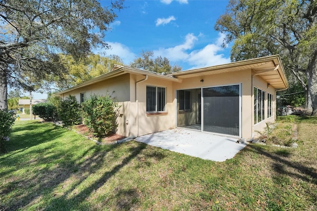 8420 Winding Wood Dr, Port Richey, FL 34668 - back of house with a patio area, a yard, and stucco siding