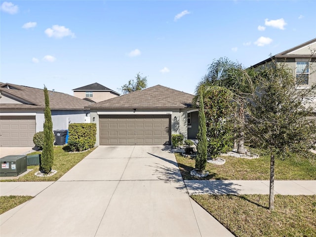 ranch-style house featuring a garage, driveway, and stucco siding