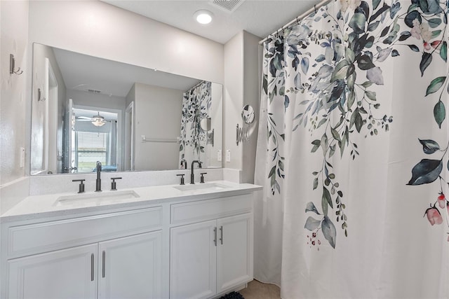 full bath featuring a sink, visible vents, and double vanity