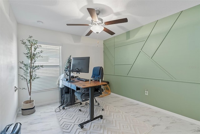 office space with marble finish floor, baseboards, and ceiling fan