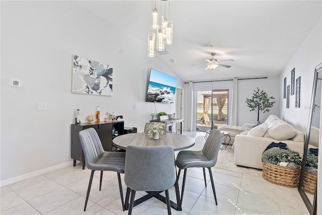 dining room featuring lofted ceiling, light tile patterned floors, ceiling fan with notable chandelier, and visible vents