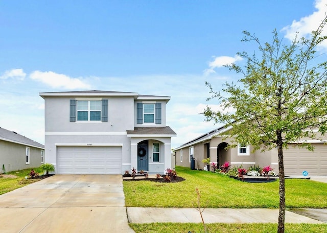 traditional home with a front yard, driveway, an attached garage, and stucco siding