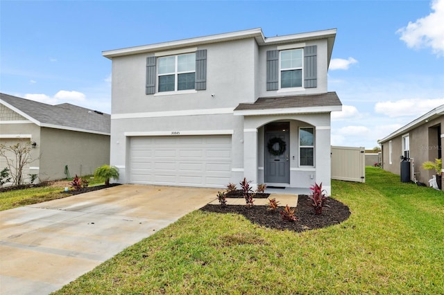 traditional-style house with a garage, driveway, a front lawn, and stucco siding