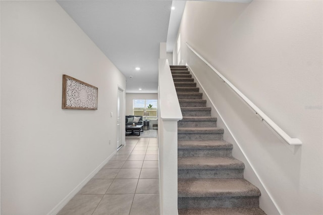 stairway featuring baseboards, recessed lighting, and tile patterned floors