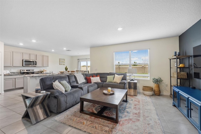 living room featuring light tile patterned floors, a textured ceiling, a wealth of natural light, and recessed lighting