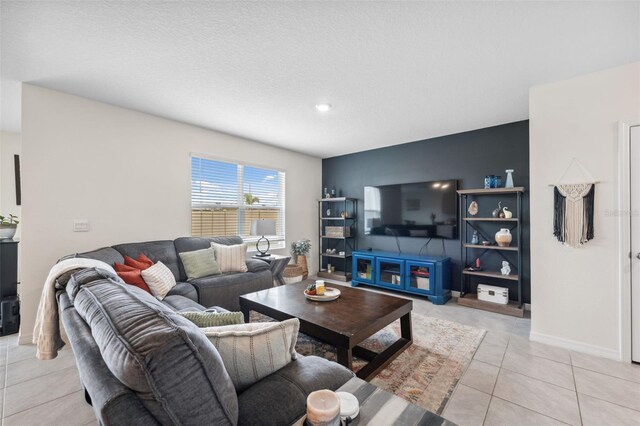 living area with light tile patterned floors and baseboards