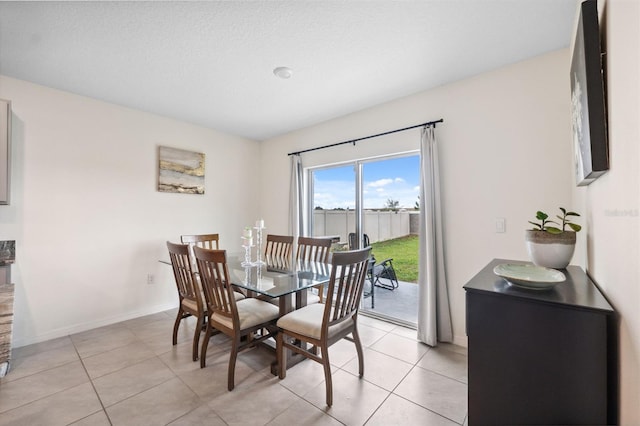 dining room with baseboards and light tile patterned floors