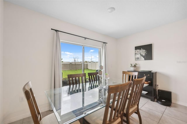 dining area featuring baseboards and light tile patterned floors