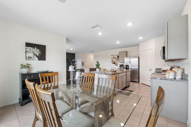 dining space with light tile patterned floors, baseboards, visible vents, and recessed lighting