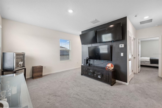 living area with recessed lighting, carpet flooring, visible vents, and baseboards