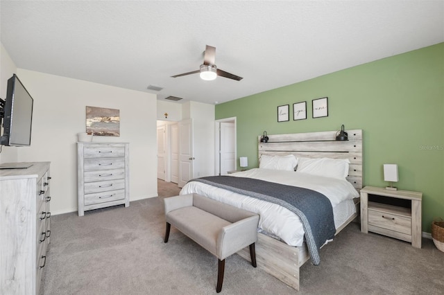 bedroom with carpet floors, baseboards, visible vents, and a ceiling fan