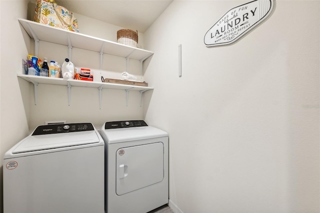 clothes washing area featuring washing machine and dryer and laundry area