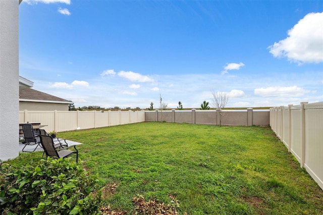 view of yard with a fenced backyard