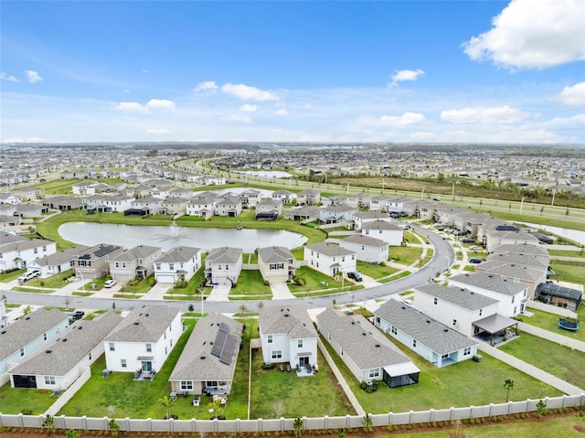 birds eye view of property with a water view and a residential view