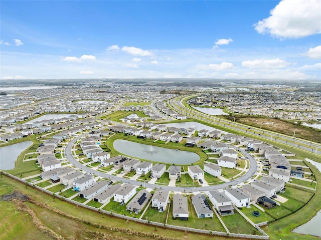 drone / aerial view featuring a water view and a residential view