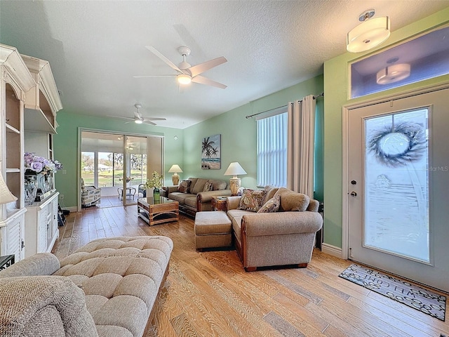 living area featuring a textured ceiling and light wood-style floors