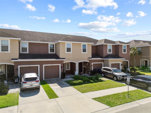 multi unit property featuring a garage, driveway, a shingled roof, and stucco siding