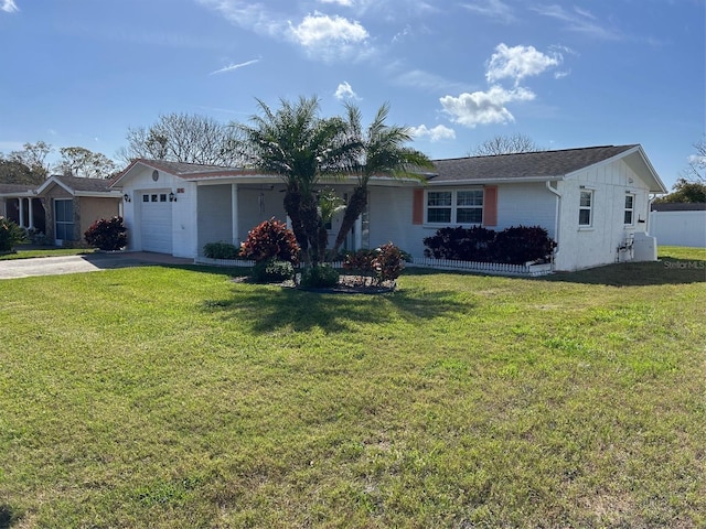 single story home featuring a garage, driveway, and a front yard