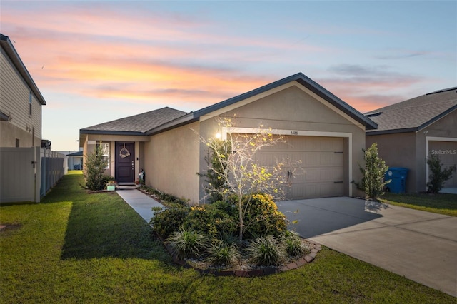 view of front of house with a garage, driveway, a shingled roof, a front lawn, and stucco siding