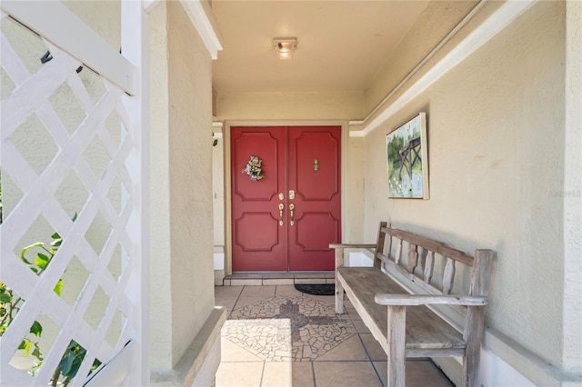 view of exterior entry with stucco siding